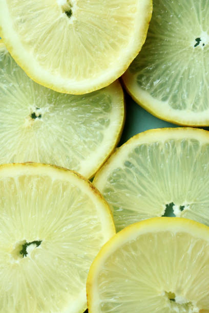 istock Pile of fresh lemon slices on blue plate 2179130735