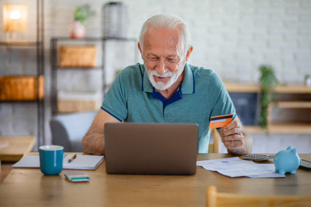 istock Senior paying online with credit card at home 2179132071