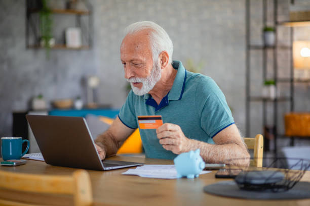 istock Senior paying online with credit card at home 2179135427