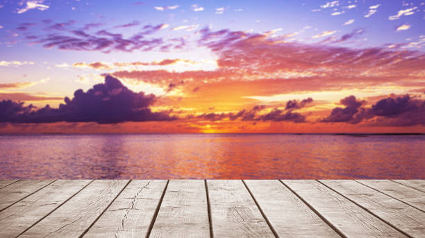 istock Empty wooden table top with tropical ocean sunrise background 2179139837
