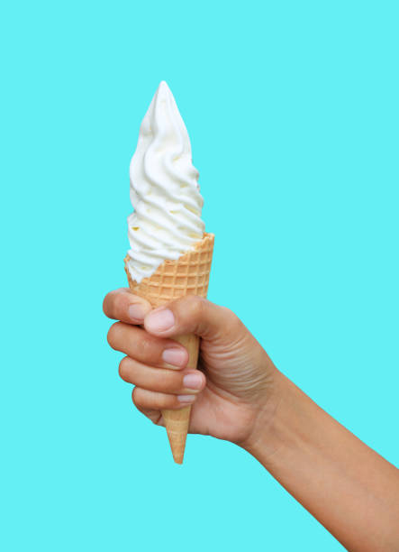 istock Hand holding a vanilla ice cream cone isolated on cyan background. 2179143562