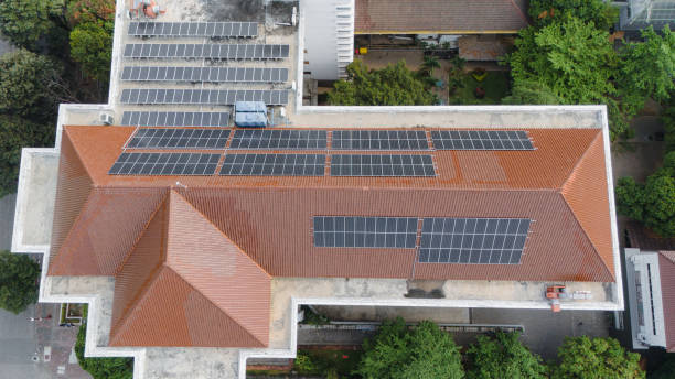 istock Renewable energy systems are being installed on a office building's rooftop in a city 2179145720