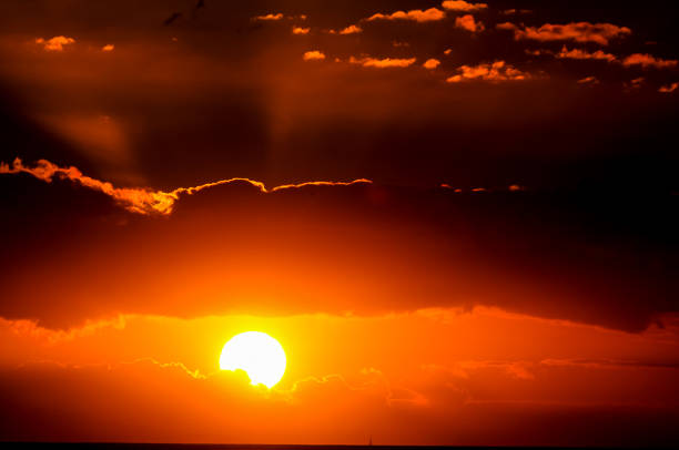 istock The sun is setting and the sky is filled with clouds 2179146122
