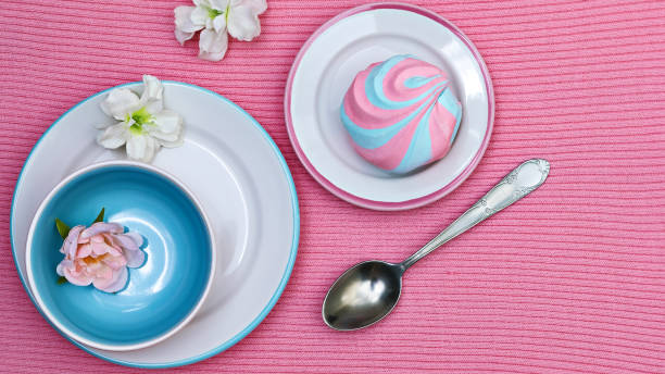 istock Colorful fluffy marshmallow on saucers on a pink knitted background 2179146163