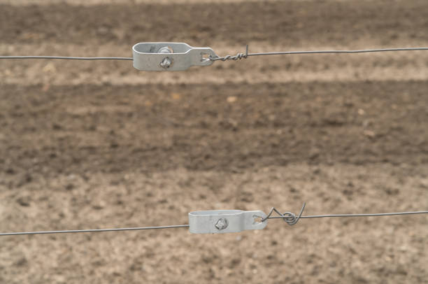 2 wire tensioners in front of a brown background