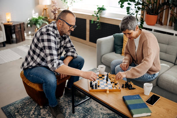 istock Couple playing chess at home 2179150794