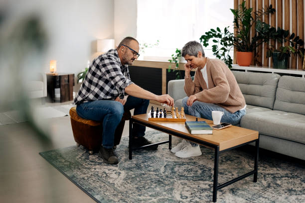 istock Couple playing chess at home 2179150801