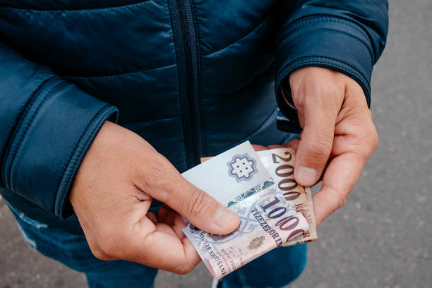 istock man has some hungarian forint notes in his hands 2179152022