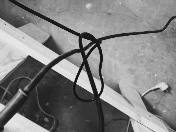 istock Tangled wire. Construction - tangled cord. Black and white photo - tangled cable . 2179153144