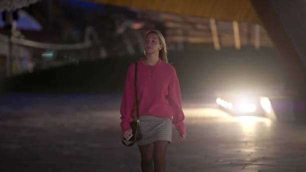 istock A young woman confidently walks at night through an urban setting with exciting visuals 2179154717