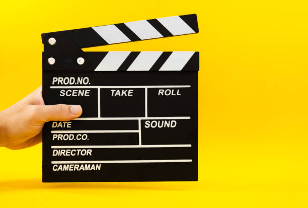 istock male hand holding film clapperboard 2179155395