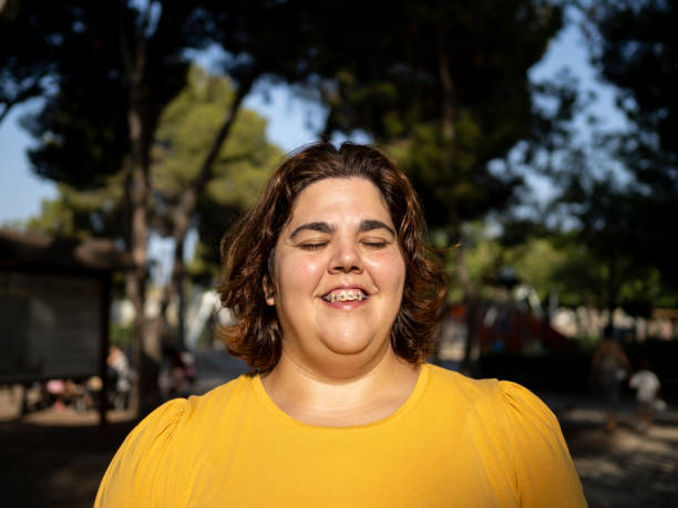 istock Smiling young woman with intellectual disability enjoying at a sunny park 2179155406
