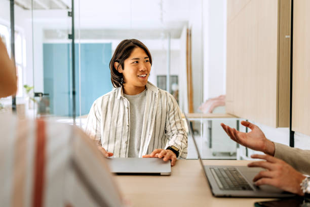 istock Young business colleagues talking during meeting at modern board room 2179156567