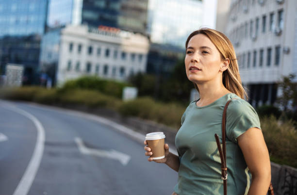 istock Happy Caucasian woman with takeaway coffee. 2179157148