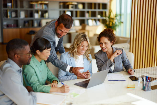 istock Happy business team working on laptop in the office. 2179157761