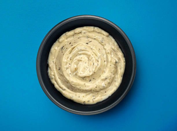 istock Garlic dip sauce in black bowl on blue background, top view 2179158018