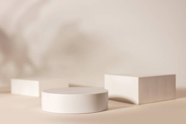 istock Minimalistic white platforms of varying shapes, placed on a soft beige background. 2179158723