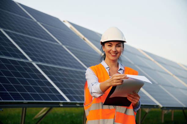 istock Female worker engineer in uniform is near solar panels 2179159644