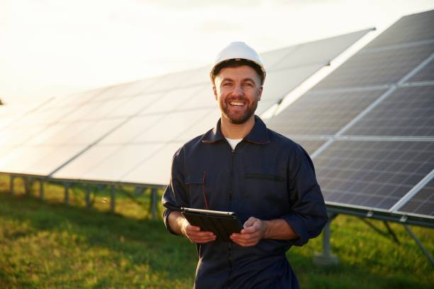 istock Digital tablet in hands. Man is working with solar panels outdoors at daytime 2179159916