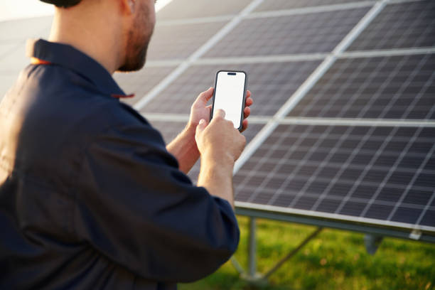 istock Phone in hands, internet connection. Man is working with solar panels outdoors at daytime 2179159923
