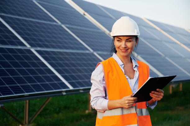 istock Checking the data, with notepad. Female worker engineer in uniform is near solar panels 2179160015