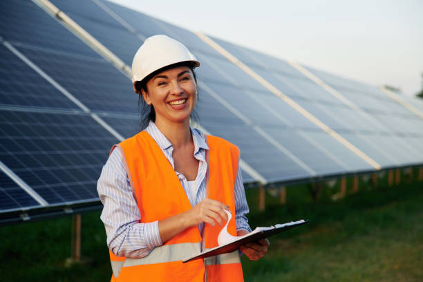 istock Checking the data, with notepad. Female worker engineer in uniform is near solar panels 2179160022