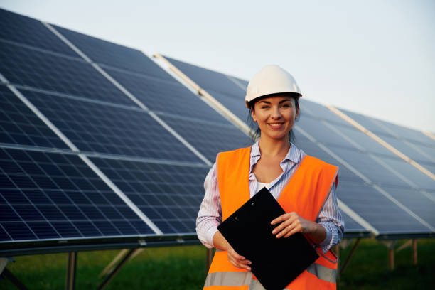 istock Female worker engineer in uniform is near solar panels 2179160051
