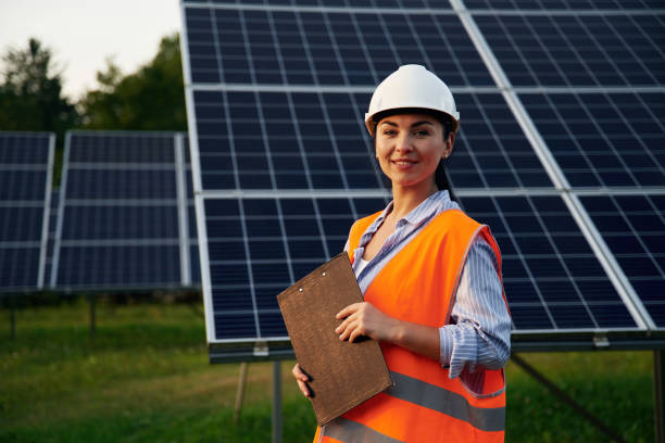 istock Female worker engineer in uniform is near solar panels 2179160066