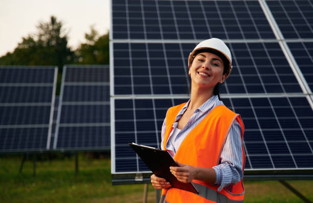 istock Female worker engineer in uniform is near solar panels 2179160067