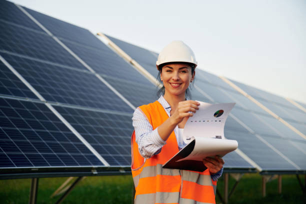 istock Female worker engineer in uniform is near solar panels 2179160076