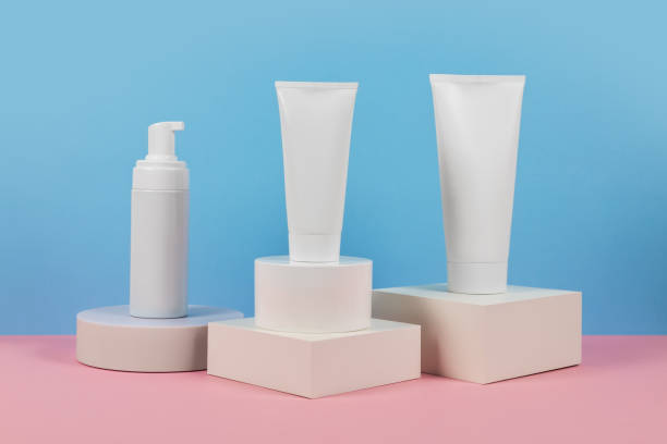 istock White plastic tubes without label displayed on podium. Scene for advertising cosmetics base 2179160506