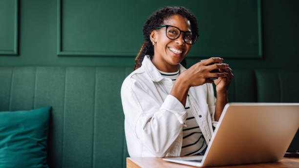 istock Happy black woman smiling while working on her laptop 2179161602