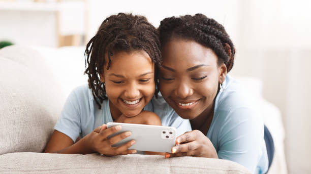Black girl and mom holding iPhone 11 pro max