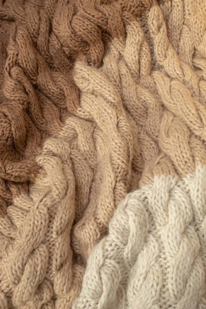 istock Winter wool hand-knit beige sweater. Clothes textile background 2179163696