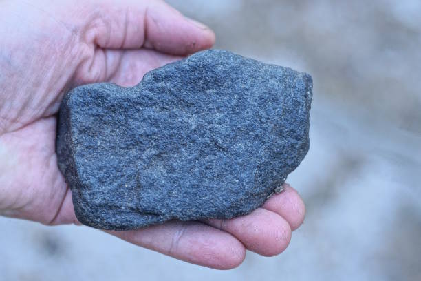istock hand holding one large piece of black coal 2179164154