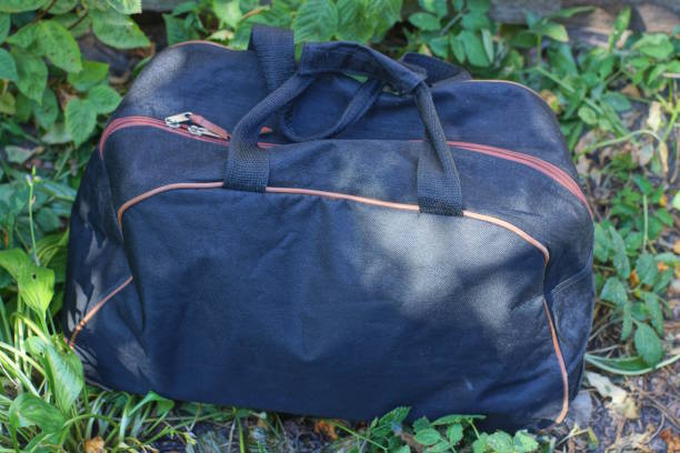 istock one large full black cloth bag stands on the grey ground 2179164409