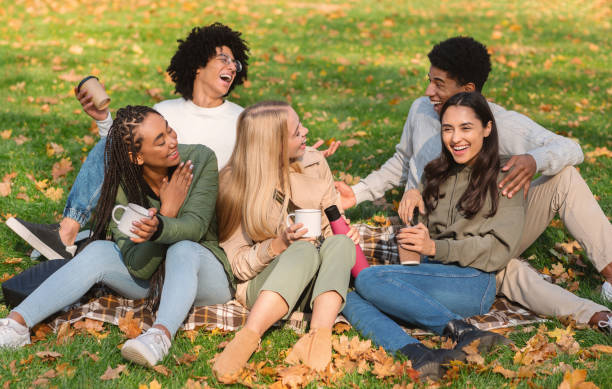 istock Joyful friends talking and laughing, picnic at park 2179167276