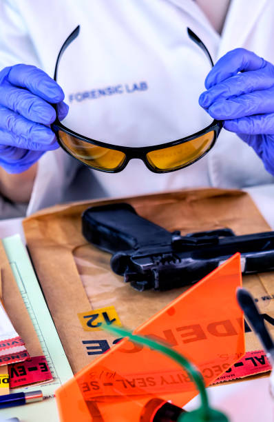 Man with a blindfold holds eye glasses