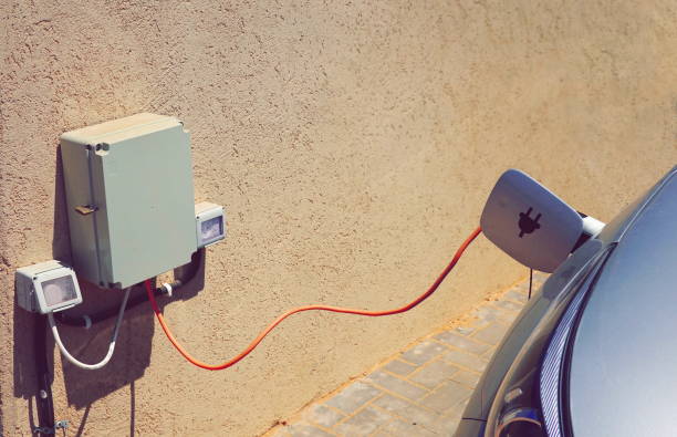 istock Electric Car Charging Station Close-Up Beige Wall Background 2179167628