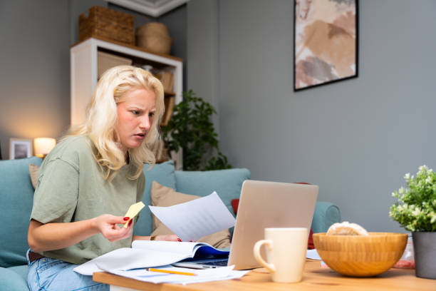 istock Young freelance business finance woman has a problem with attention deficit hyperactivity disorder ADHD she cant start work on project. Female lost concentration cant work from home on laptop computer 2179168192