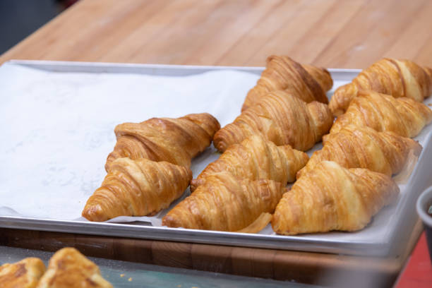 istock fresh baked brown croissants on baking sheet 2179168936