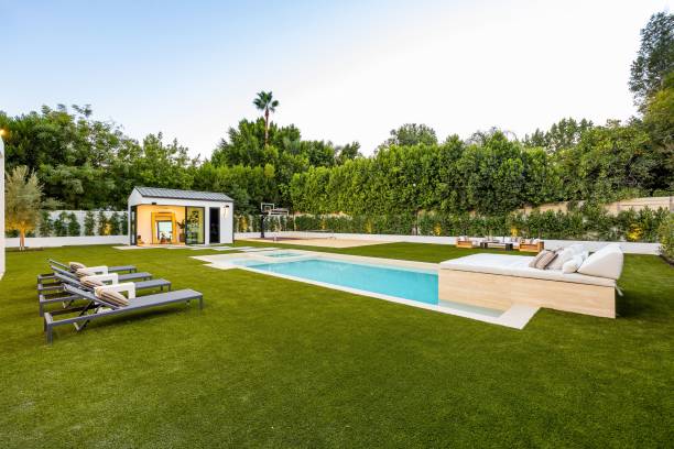 istock Luxurious backyard with modern pool and sun loungers. 2179169897