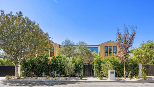 istock Modern wooden house with lush greenery. 2179170023