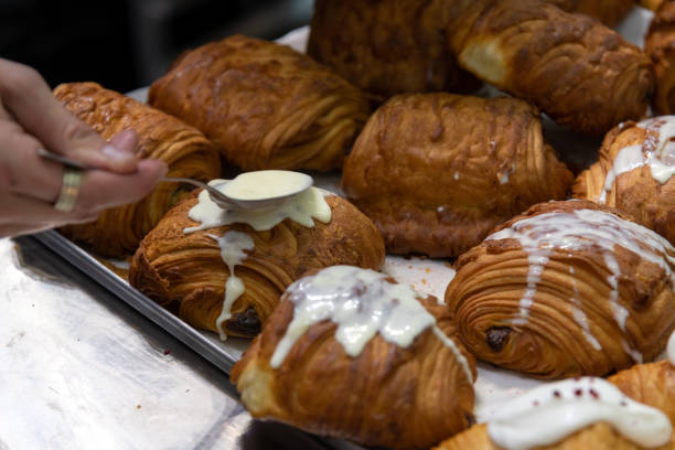 istock Cook pouring glazing on croissants 2179170256