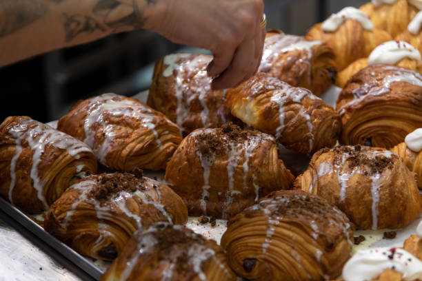 istock cook sprinkles cookie crumbs on chocolate croissants 2179170273
