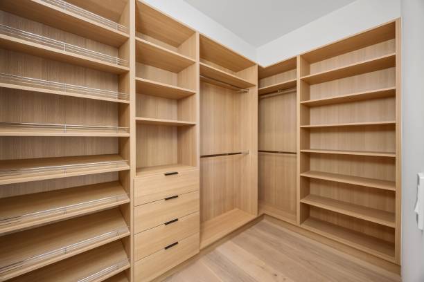 istock Modern walk-in closet with wooden shelves. 2179170283