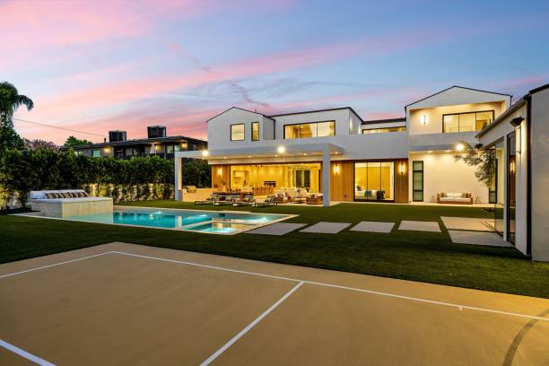 istock Modern luxury home exterior with pool and court at sunset. 2179170366