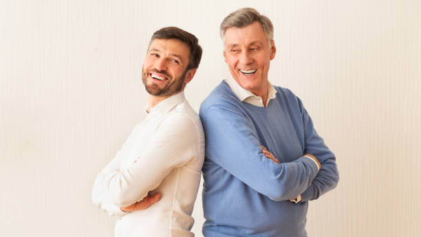 istock Mature Man And Father Standing Back-To-Back Crossing Hands, White Background 2179170804