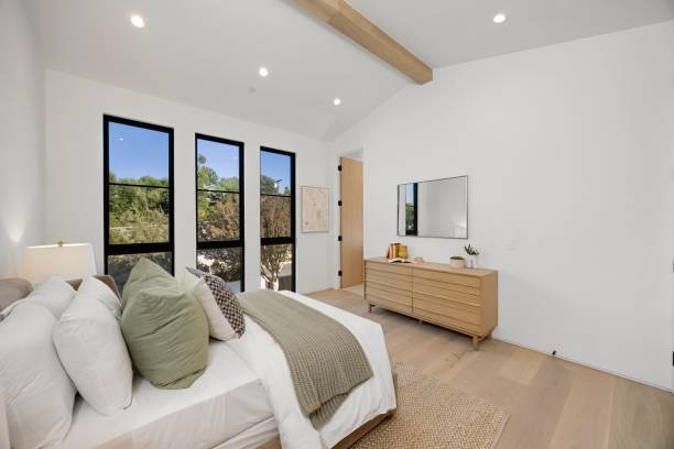 istock Modern bedroom with large windows and neutral decor. 2179170994
