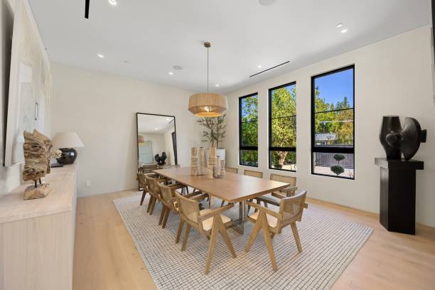 istock Modern dining room with wooden table and large windows 2179171017